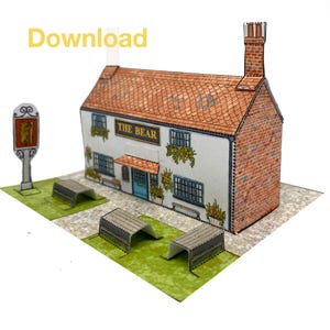 May include: A paper model of a pub called "The Bear" with a red-tiled roof, brick chimney, and blue window frames. The model includes a sign, benches, and a green lawn. The text "Download" is in the upper left corner.