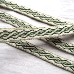 May include: Two green and white woven ribbon trim with a braided pattern.