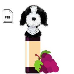 May include: A whimsical wine bottle stopper featuring a plush black and white dog with a crocheted collar. The stopper is atop a bottle illustration with a label and a cluster of purple grapes with green leaves.