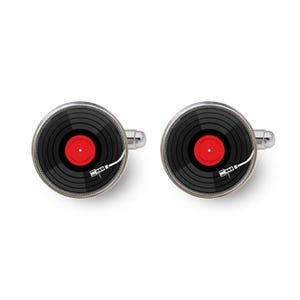 May include: A pair of silver cufflinks with a black and red vinyl record design. The record has a red label and a silver tone needle.
