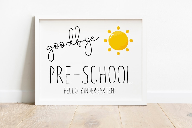 Puede incluir: Una impresi&oacute;n enmarcada en blanco con texto negro que dice "goodbye PRE-SCHOOL" y "HELLO KINDERGARTEN!". Una ilustraci&oacute;n de sol amarillo est&aacute; en la esquina superior derecha. Un art&iacute;culo decorativo para un aula o un hogar.