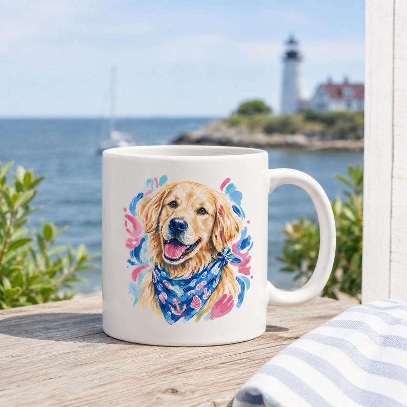 May include: White ceramic mug featuring a watercolor illustration of a Golden Retriever wearing a blue bandana with anchor and seashell designs. The dog is surrounded by pink and blue brushstrokes. The mug has a white handle.