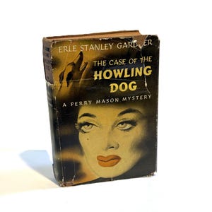 May include: Vintage book titled "The Case of the Howling Dog" by Erle Stanley Gardner. The cover features a woman's face and a howling dog illustration. A Perry Mason mystery.