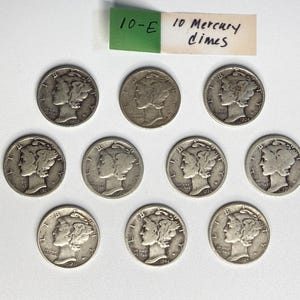 May include: Ten silver Mercury dimes arranged in three rows. Each coin features the profile of Liberty wearing a winged cap, with the text 10-E 10 Mercury dimes written on a small green and white paper tag positioned above the coins.