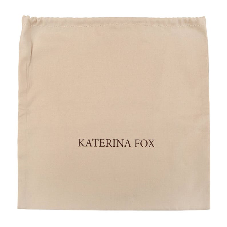 May include: A beige drawstring dust bag with the text "KATERINA FOX" printed in brown.