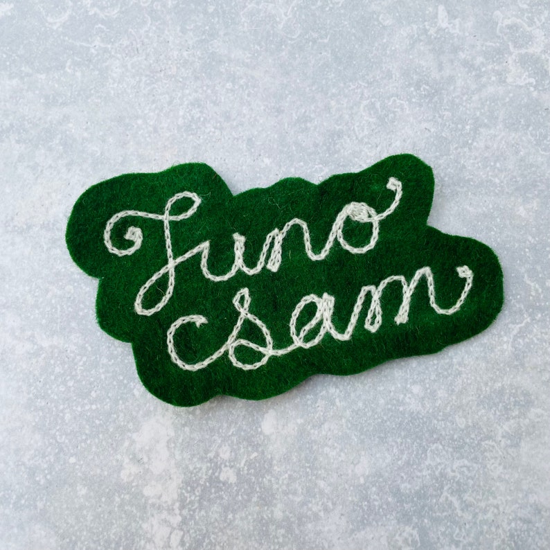 Custom vintage chain stitch name patch in green and white.