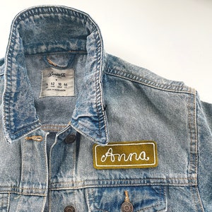 Custom Chain Stitch Name Patch on a denim jacket.