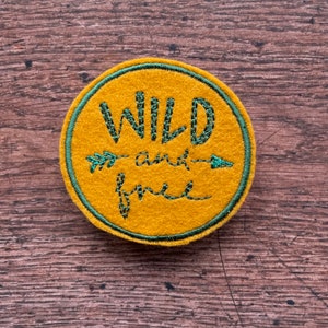 Wild and Free adventure patch in mustard and green.