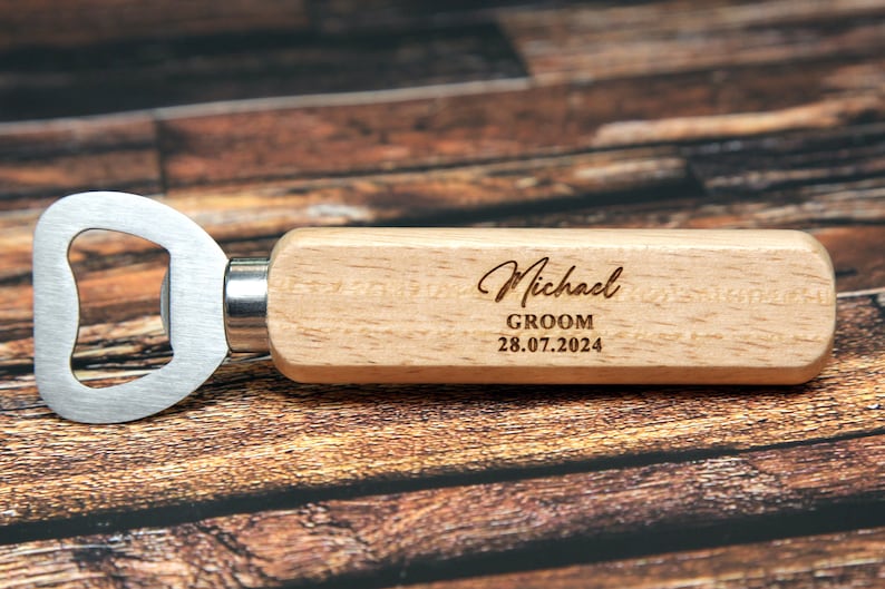 May include: Wooden bottle opener with a metal opener and a personalized inscription that reads "Michael Groom 28.07.2024".