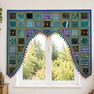 May include: A rectangular window valance featuring a patchwork design of blue, teal, and purple fabric squares with gold embroidery and sequins. The bottom edge is arched and trimmed with a row of small, multicolored pom-poms along the border.