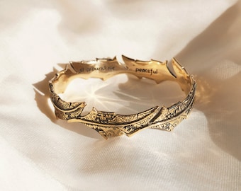 Bronze Feather Bangle with Batik Pattern Engraved with the words "All around me peaceful"