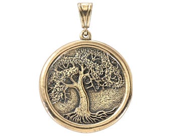 May include: A gold-toned pendant featuring a detailed tree of life design. The pendant is round and has a smooth, polished finish.