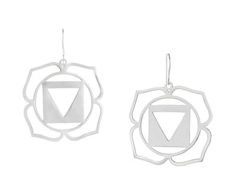 May include: Silver earrings with a lotus flower design and a triangle symbol inside. The earrings are a symbol of the root chakra.