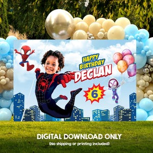 Pu&ograve; includere: Uno sfondo rettangolare per compleanni con un bambino in un costume da ragno nero e rosso, Spider-Man e Ghost-Spider. Il testo Happy Birthday Declan e una stella gialla con il numero 6 sono raffigurati sopra lo skyline di una citt&agrave;.