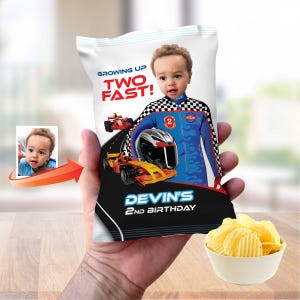 Può includere: Un sacchetto di patatine personalizzato a tema racing. La confezione presenta l'immagine di un bambino, auto da corsa e il testo "Growing Up Two Fast!" e "Devin's 2nd Birthday". Una piccola ciotola di patatine è in primo piano.