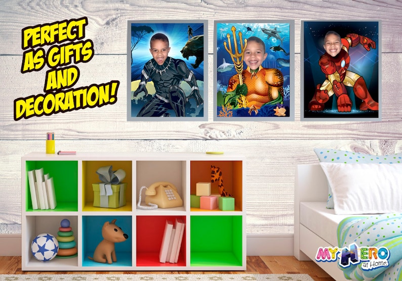 May include: Three framed superhero portraits hang on a white wood-paneled wall. The portraits feature a young person's face superimposed on superhero bodies: Black Panther, Aquaman, and Iron Man. A white storage unit with colorful cubbies is in the foreground.
