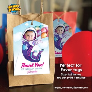 May include: A colorful thank you tag with a cartoon image of a child dressed as Spider-Man. The tag has the text "Thank You!" and "For swinging by my party. Alexandra". The tag is perfect for a birthday party favor.