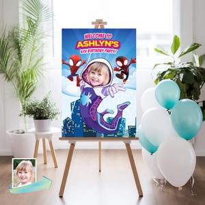 May include: A personalized party sign on an easel, featuring a child's photo and the text "WELCOME TO ASHLYN'S 4TH BIRTHDAY PARTY!" The design includes Spider-Man characters and a cityscape background, with balloons in the background.