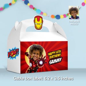 May include: Red and white gable box favor with a superhero theme. The box features a photo of a child dressed as Iron Man, a red and yellow Iron Man mask, and the text "Happy 6th Birthday Sammy". The box is 6.2 inches by 3.5 inches.