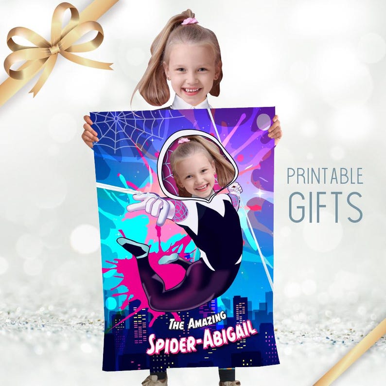 May include: A vibrant blanket featuring a cartoon illustration of a superheroine in a dynamic pose, set against a cityscape and a web design. The text "THE AMAZING SPIDER-ABIGAIL" is displayed at the bottom. The words "PRINTABLE GIFTS" are also visible.