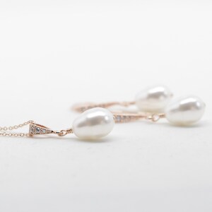 May include: A set of pearl earrings and a necklace with a delicate rose gold chain and small diamond accents.