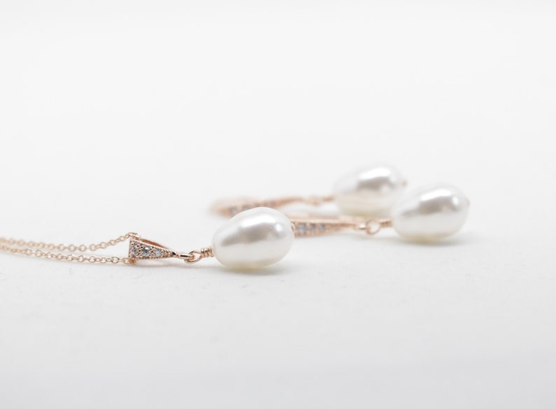 May include: A set of pearl earrings and a necklace with a delicate rose gold chain and small diamond accents.