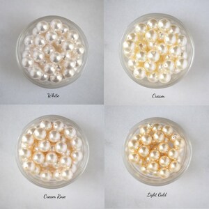 May include: Four bowls of pearl beads in different colors: white, cream, cream rose, and light gold.