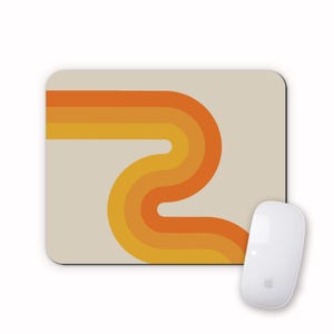 May include: A retro-style mouse mat with a design of orange, yellow and brown curved lines on a beige background.