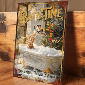 May include: A metal sign featuring a giraffe enjoying a bubble bath. The sign displays the text "It's Bath Time" and "Soak Your Troubles Away." The giraffe is in a marble-effect tub with gold taps, surrounded by tropical plants.
