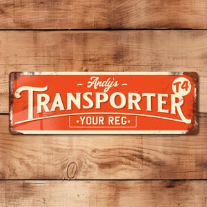 Op de afbeelding: Rood en wit metalen bord met de tekst "Andy's Transporter - Your Reg." en het nummer "T4" in een cirkel. Het bord heeft een verweerde uitstraling, waardoor het een vintage uitstraling heeft.