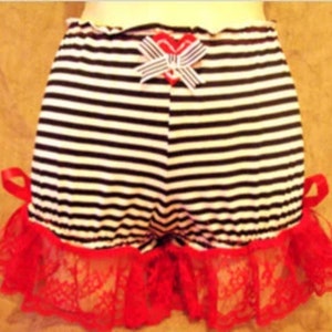 May include: Black and white striped cotton shorts with a red and white bow and red lace trim.