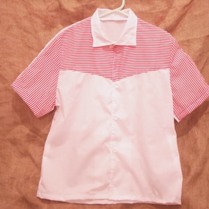 May include: A white and red striped short-sleeved shirt with a white collar and a white front panel.