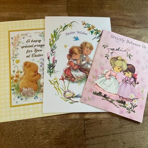 May include: Three vintage Easter greeting cards. One card has a teddy bear and bunny illustration with the text "A beary special prayer for You at Easter". Another card has children praying with the text "Easter Wishes". The third card has two girls with the text "Strictly Between Us".