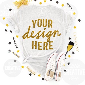 MOCKUP - Bella Canvas 3413 White Fleck Triblend Shirt Flat Lay Mockup Celebration New Years Stars Confetti Blow Out on White Background