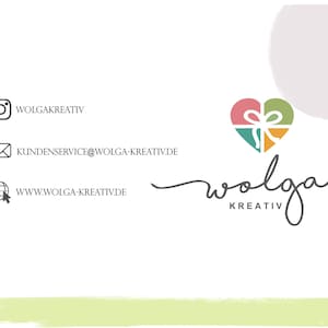 May include: A logo for a creative business called "Wolga Kreativ" featuring a heart-shaped gift box with a bow in shades of pink, green, yellow, and orange. The logo is on a white background with a light green border.