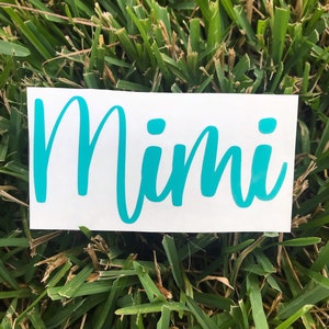 May include: A white vinyl sticker with the word "Mimi" written in turquoise cursive lettering.