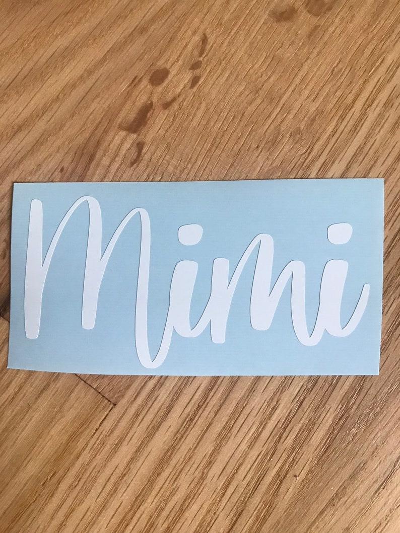 May include: A light blue vinyl sticker with the word "Mimi" written in white cursive lettering.