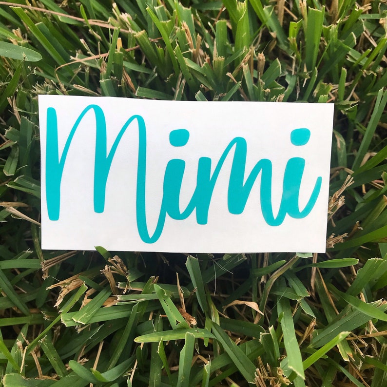 May include: A white vinyl sticker with the word "Mimi" written in turquoise cursive lettering.