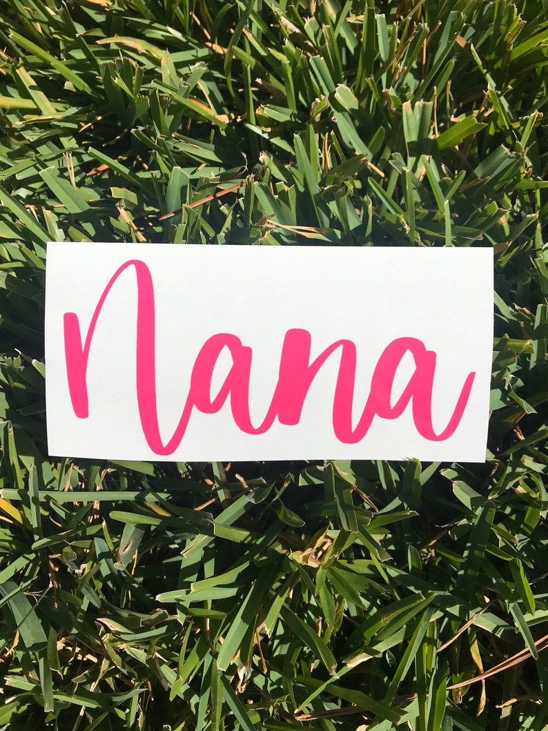 May include: A white vinyl sticker with the word "Nana" written in pink cursive lettering.