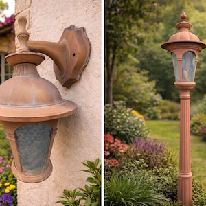 May include: Two outdoor lamps with a weathered copper finish. One is mounted on a wall, the other is a freestanding lamp post. Both have glass panels and are surrounded by lush landscaping.