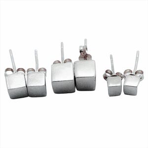 May include: Three pairs of silver cube stud earrings. The earrings are in three different sizes.