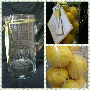 May include: A glass pitcher with a etched design that says "When life gives you lemons make lemonade". The pitcher is filled with lemons.