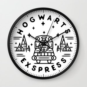 May include: Black and white clock with a Hogwarts Express train design. The clock face features a train engine, stars, and the words "Hogwarts Express".