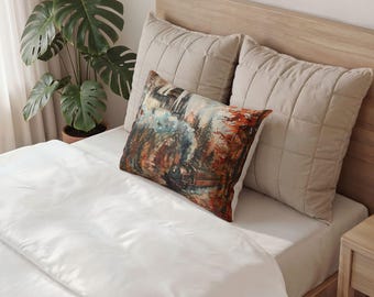 May include: A rectangular throw pillow featuring a detailed illustration of a steam locomotive traveling through a forest with autumn foliage and a castle in the background, placed in front of two large, quilted, beige square pillows.