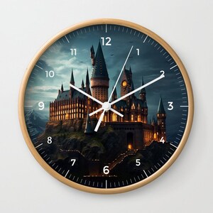 May include: A round wooden clock with a black face and white hands. The clock face features a detailed illustration of Hogwarts castle from the Harry Potter series. The numbers 1 through 12 are displayed around the edge of the clock face.