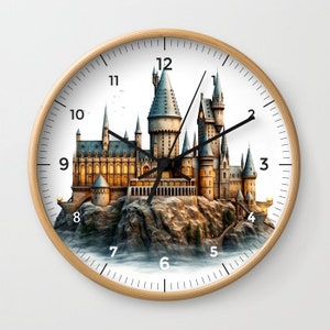 May include: A round clock with a white face and black hands. The clock face features a detailed illustration of Hogwarts castle, a fictional school of witchcraft and wizardry, from the Harry Potter series. The numbers 1 through 12 are printed around the edge of the clock face.