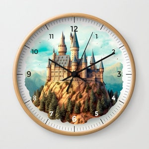 May include: A round clock with a white face and black hands. The clock face features a whimsical illustration of a castle on a mountain with trees and a blue sky. The numbers 1 through 12 are printed around the clock face.
