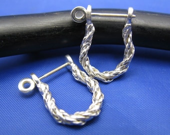 May include: A pair of silver hoop earrings with a twisted rope design. The earrings have a screw-back closure.