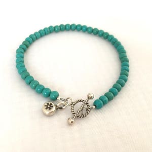Simple turquoise bracelet with artisan sterling silver toggle clasp & flower charm