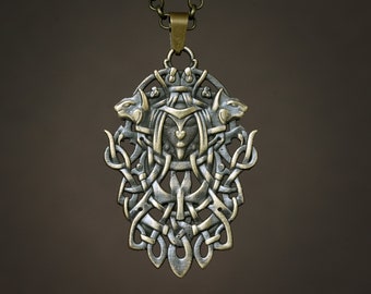 May include: An oval-shaped bronze-toned metal pendant featuring a central stylised face flanked by two animal heads. The design incorporates intricate, interwoven knotwork patterns that extend downwards, suspended from a matching metal chain.
